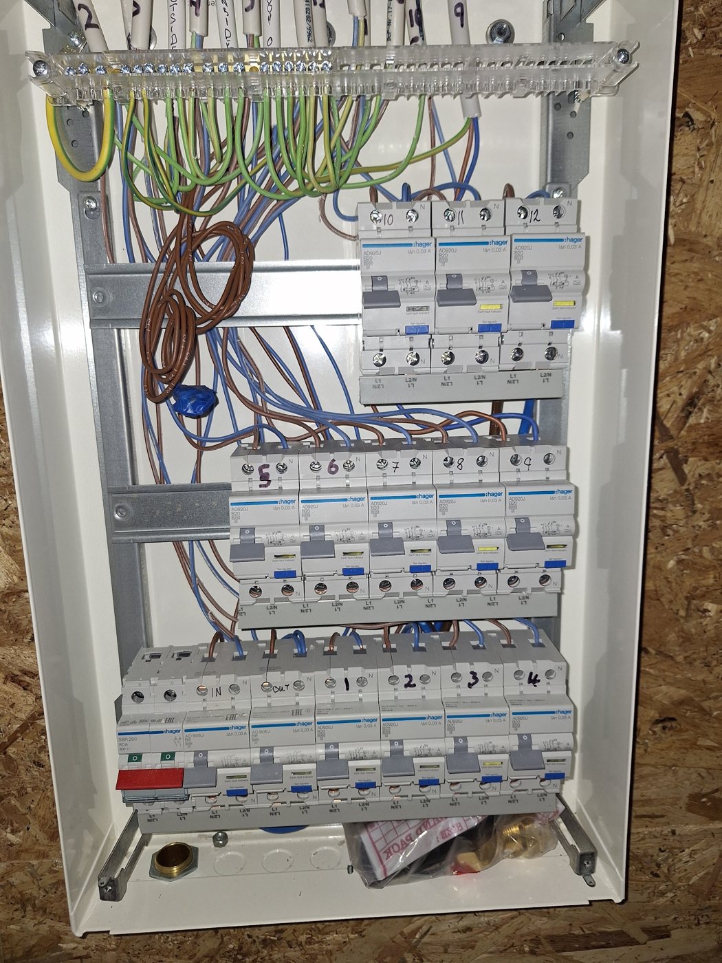 A consumer unit being wired with its cover off