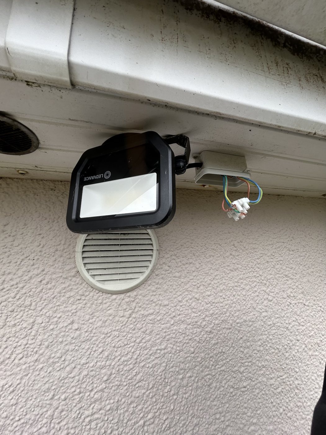 An LED floodlight fitted under a soffit